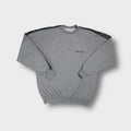 Champion grey crew-neck sweater featuring black logo tape trim along the sleeves.