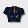 Converse half-zip sweater in blue featuring yellow trim and a Chuck Taylor patch.
