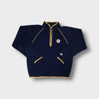 Converse half-zip sweater in blue featuring yellow trim and a Chuck Taylor patch.