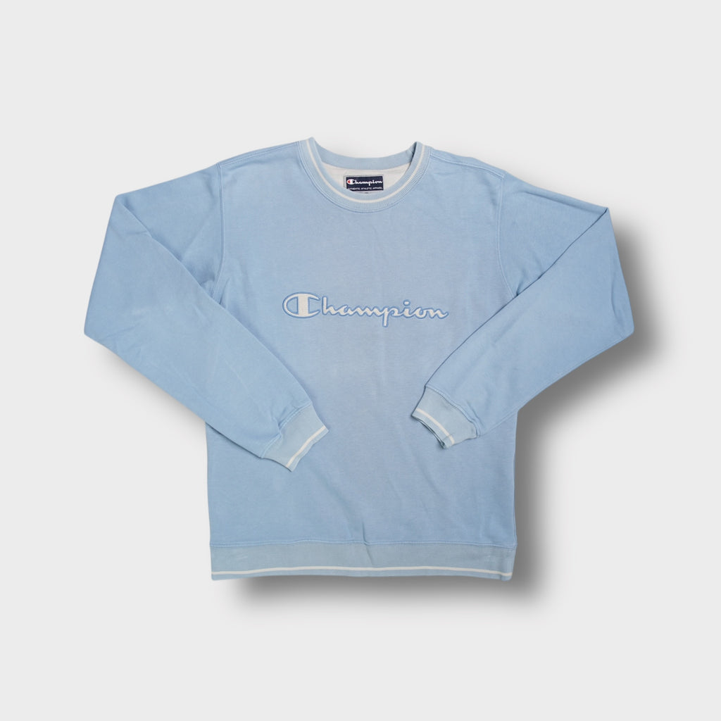 Light blue Champion crewneck sweater with white embroidered script logo across the chest