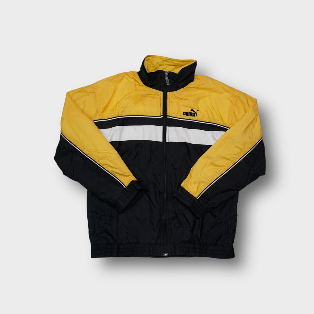Puma track jacket in yellow and black featuring an embroidered cat logo on the chest.