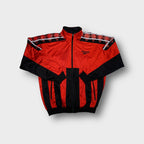 Reebok track jacket in red and black with geometric pattern tape along shoulders