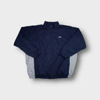 Umbro track jacket in navy blue with grey side panels and an embroidered chest logo