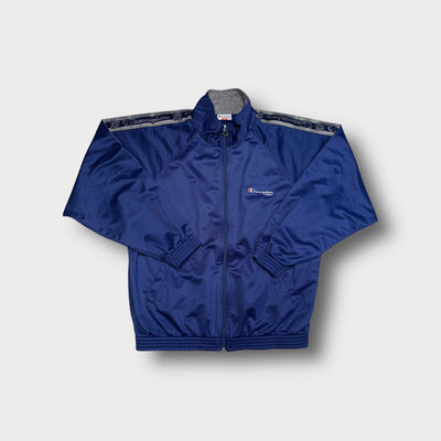 Blue Champion track jacket with logo taping along the sleeves and embroidered chest text.