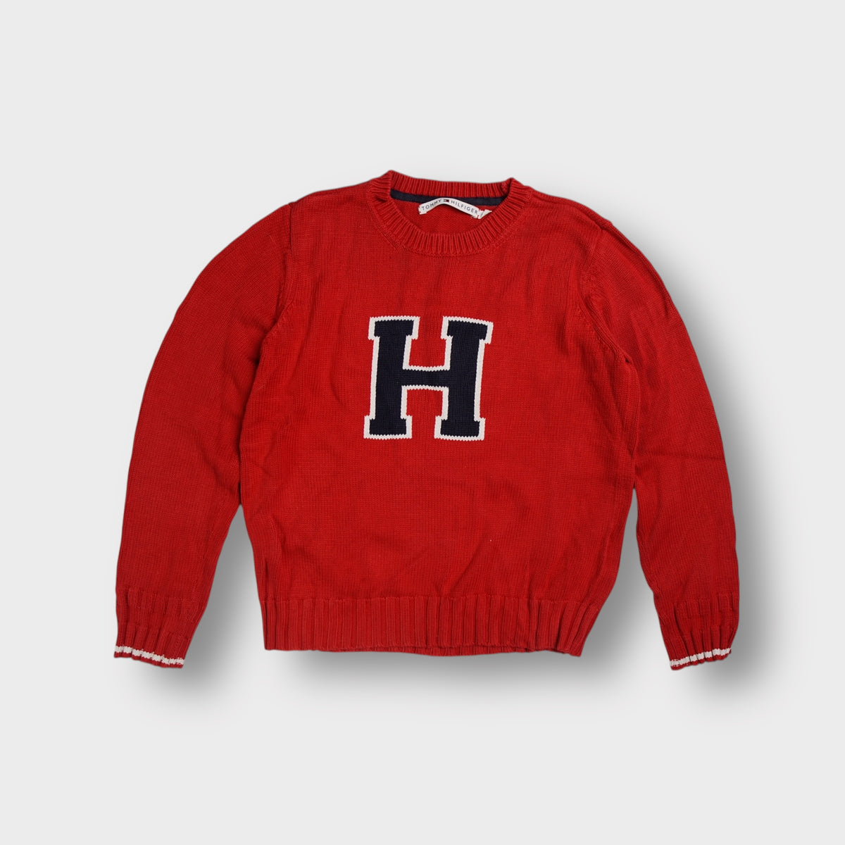 Tommy Hilfiger knit sweater in red with a large navy and white H graphic on the front