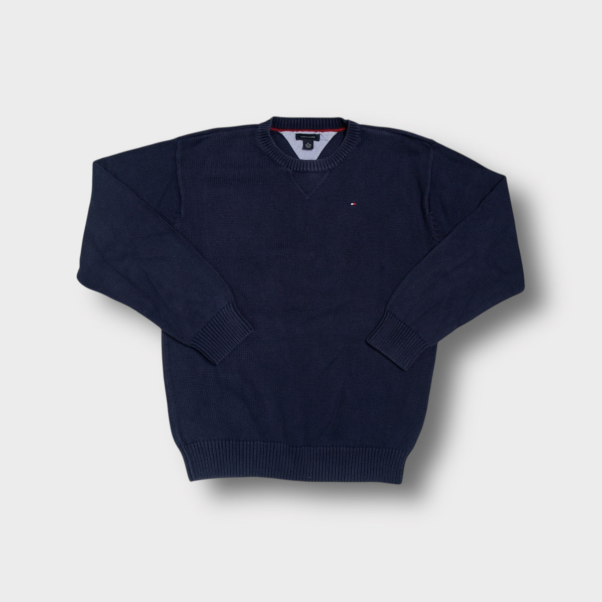 Tommy Hilfiger crew neck sweater in blue with an embroidered flag logo on the chest