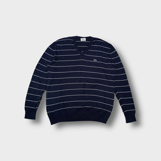 Lacoste knit sweater in navy blue featuring white horizontal stripes and a V-neck.