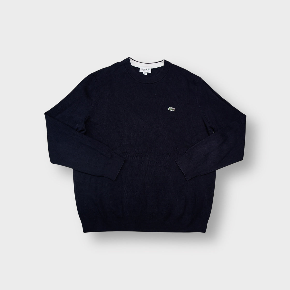 Lacoste crew-neck knit sweater in navy blue with a small embroidered crocodile logo patch