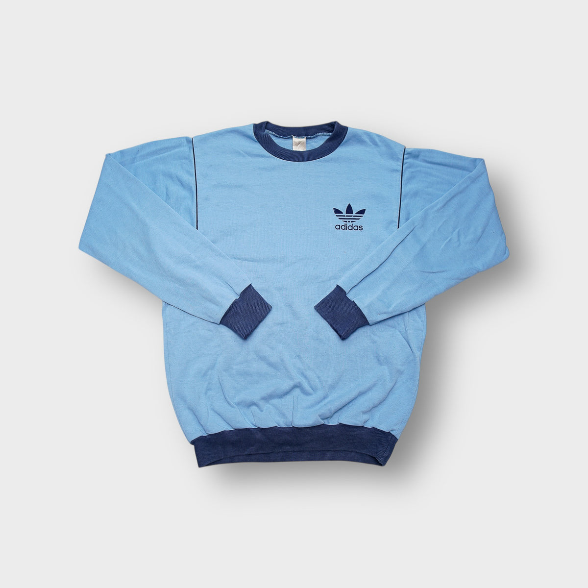 Blue Adidas sweater with contrasting dark blue crew neck collar and chest trefoil logo