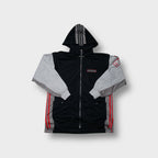 Black Adidas hooded jacket with grey contrast sleeves and red brand patch