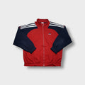 Adidas track jacket in red and navy featuring white three-stripes on shoulders