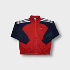Adidas track jacket in red and navy featuring white three-stripes on shoulders