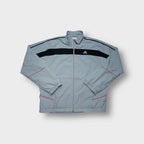 Adidas track jacket in grey featuring a black chest stripe and embroidered logo