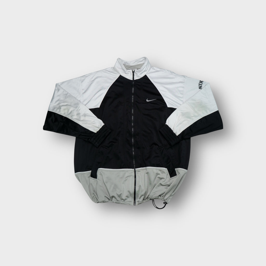 Nike track jacket in black and white with small silver embroidered swoosh logo