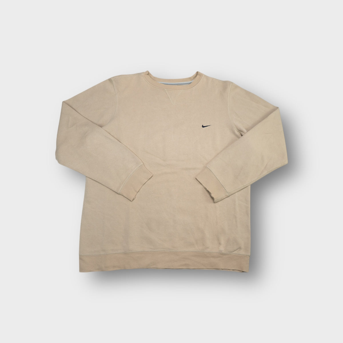 Nike sweater in beige featuring a small black embroidered swoosh on the chest