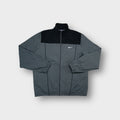 Nike track jacket in grey featuring an embroidered white swoosh logo on the chest