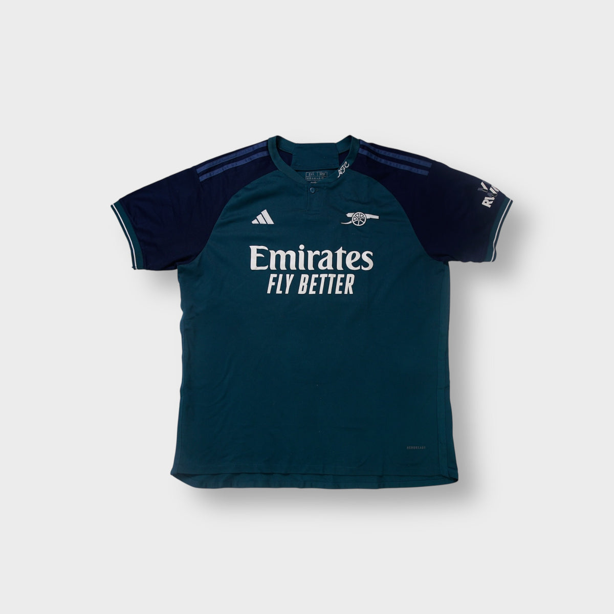 Adidas Arsenal green and navy third jersey featuring the embroidered cannon crest