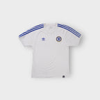 Adidas Chelsea shirt in white featuring blue shoulder stripes and woven crest patch