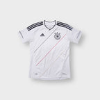 Adidas DFB white jersey featuring black stripes on the shoulders and a national team badge on the chest
