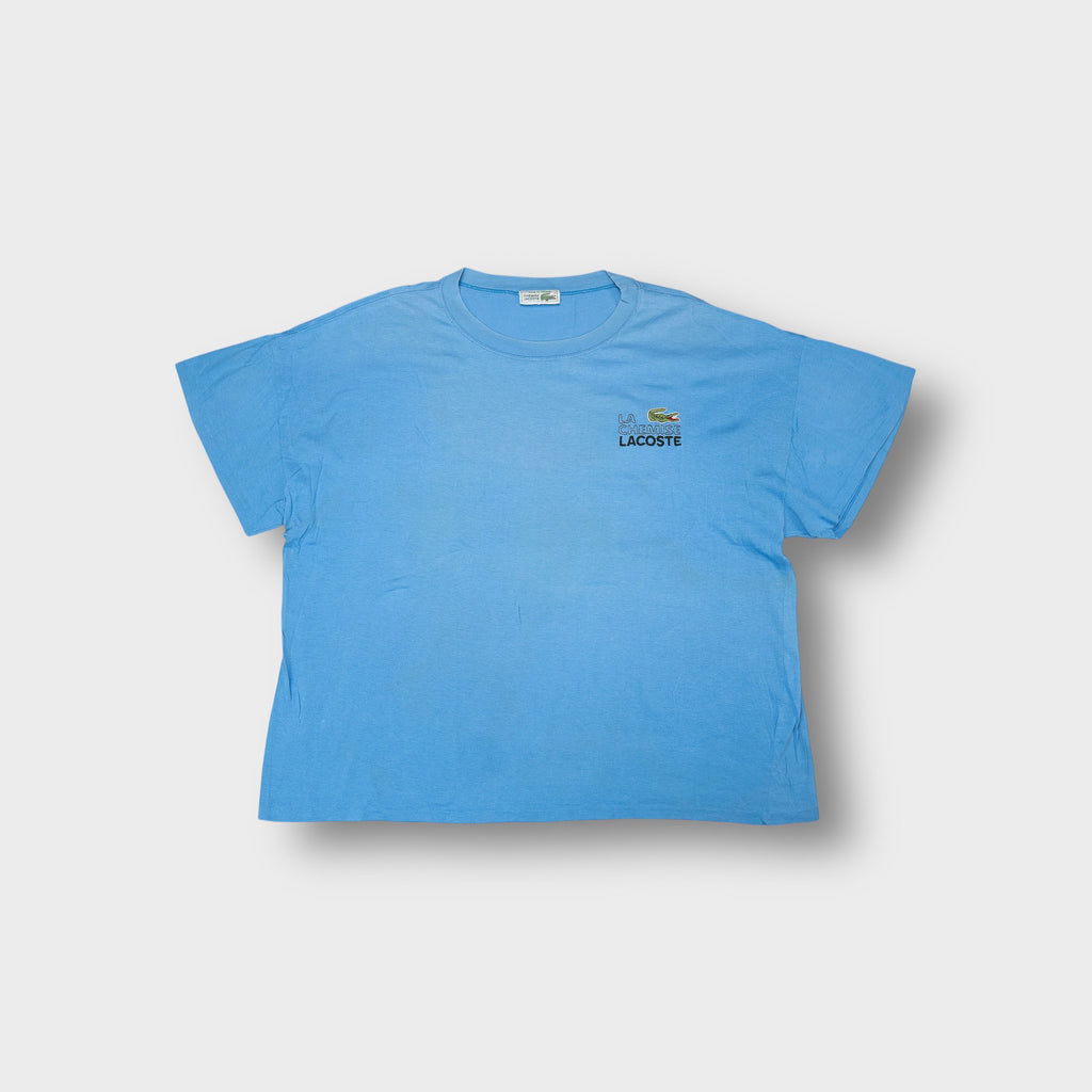 Lacoste T-Shirt in light blue featuring embroidered crocodile chest logo and Chemise Lacoste branding.