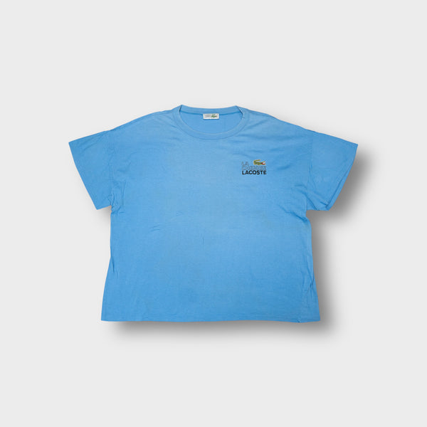 Lacoste T-Shirt in light blue featuring embroidered crocodile chest logo and Chemise Lacoste branding.