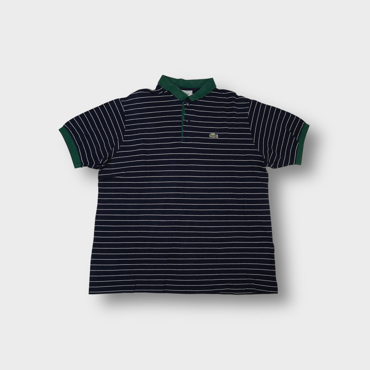 Lacoste striped navy polo shirt with a contrasting green collar and crocodile logo patch