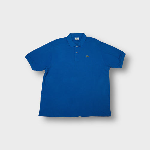 Lacoste polo shirt in blue with embroidered crocodile patch on the chest.