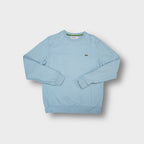 Lacoste sweater in light blue with embroidered crocodile logo on the chest