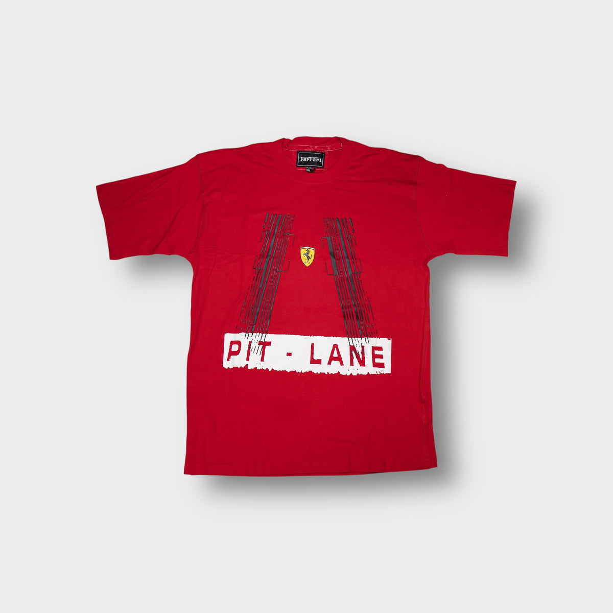 Ferrari T-Shirt in red featuring a Pit Lane print with black tire tracks and emblem.