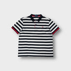 Fred Perry polo shirt in black and white stripes with a red embroidered laurel wreath logo.