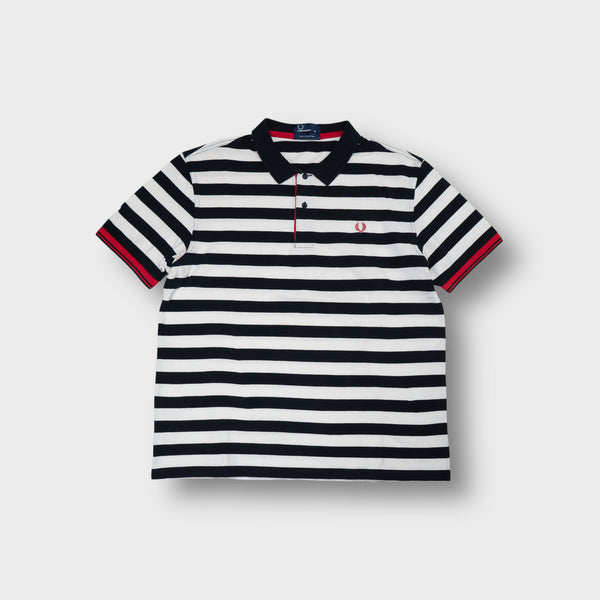 Fred Perry polo shirt in black and white stripes with a red embroidered laurel wreath logo.