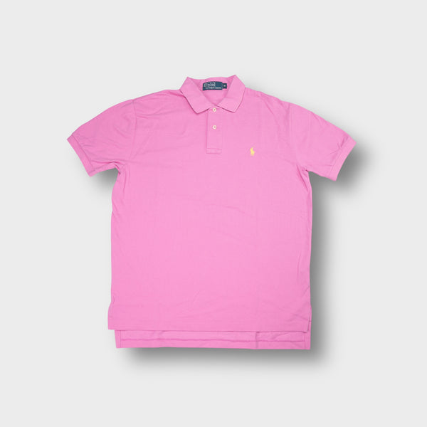 Ralph Lauren polo shirt in pink featuring a yellow embroidered pony logo on the chest