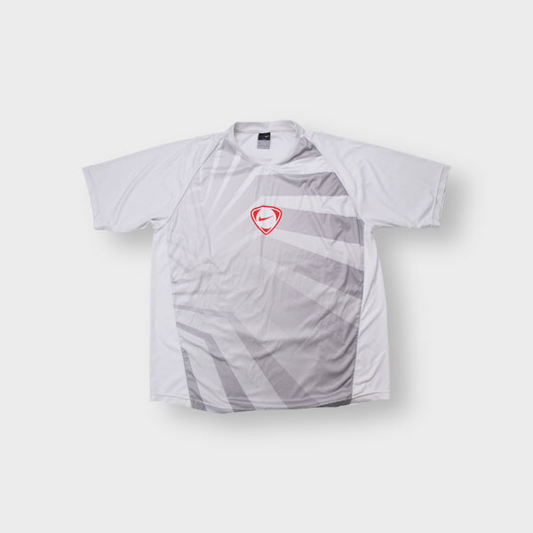 Nike Dri-FIT T-Shirt in white and grey with a red shield logo on the front panel