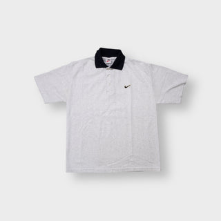 Nike polo shirt in grey with a contrasting black collar and embroidered chest swoosh logo