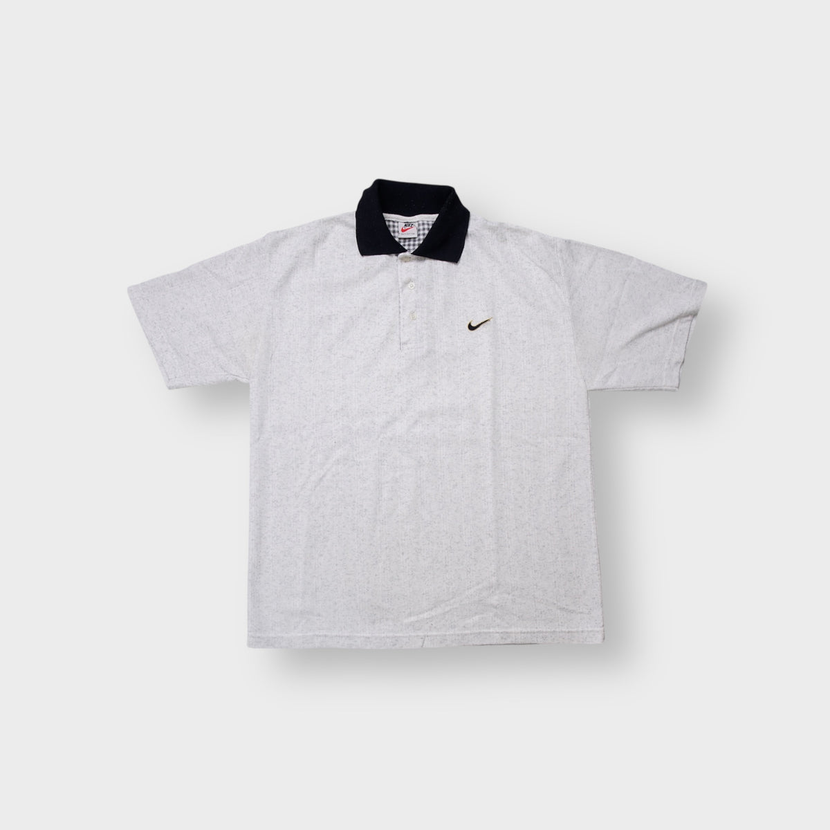 Nike polo shirt in grey with a contrasting black collar and embroidered chest swoosh logo