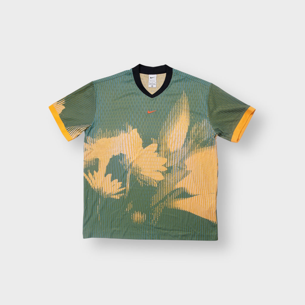 Nike jersey in green and yellow with abstract graphic design and small orange swoosh