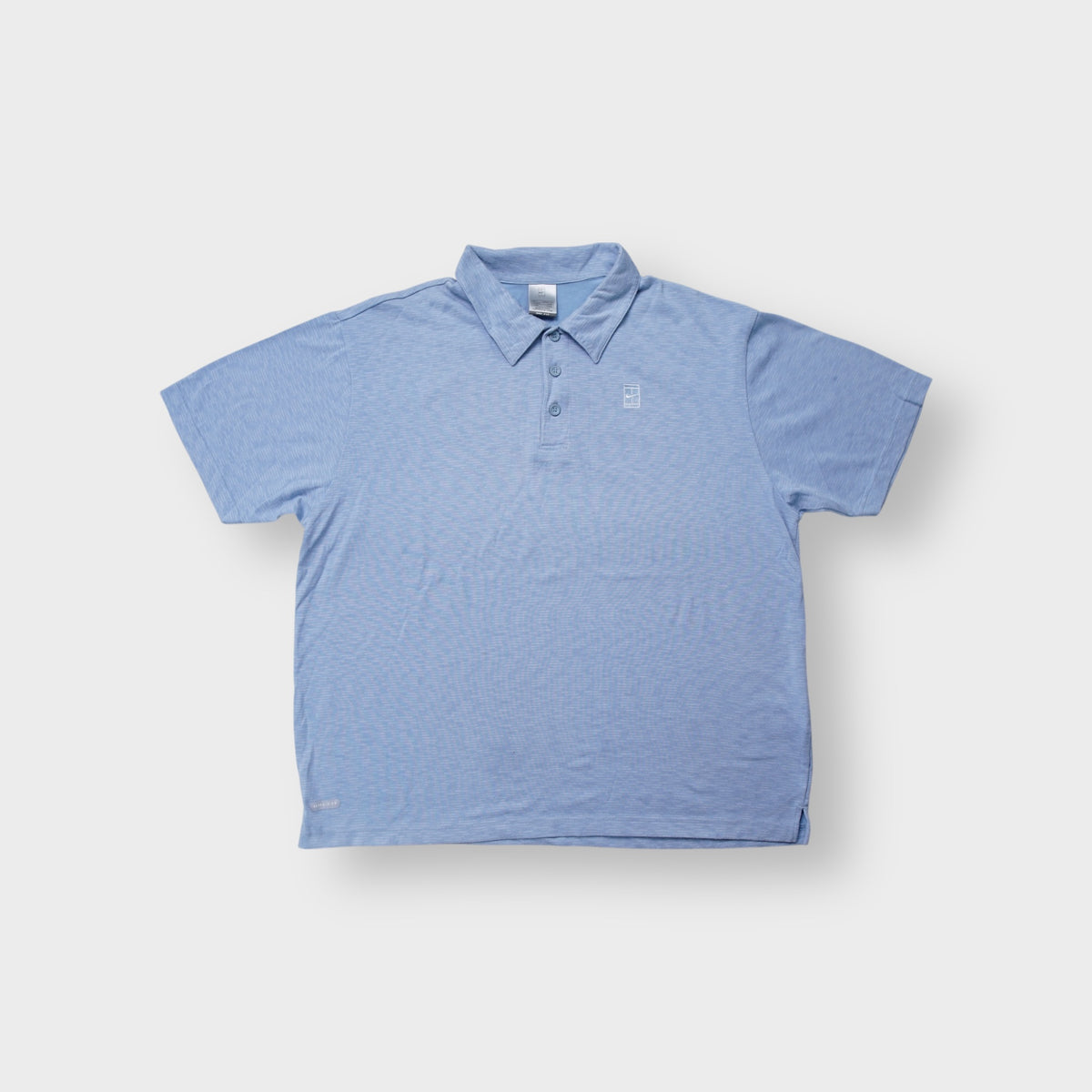 Nike polo shirt in light blue with an embroidered Nike Court tennis court logo on the chest.