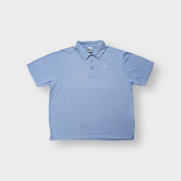 Nike polo shirt in light blue with an embroidered Nike Court tennis court logo on the chest.