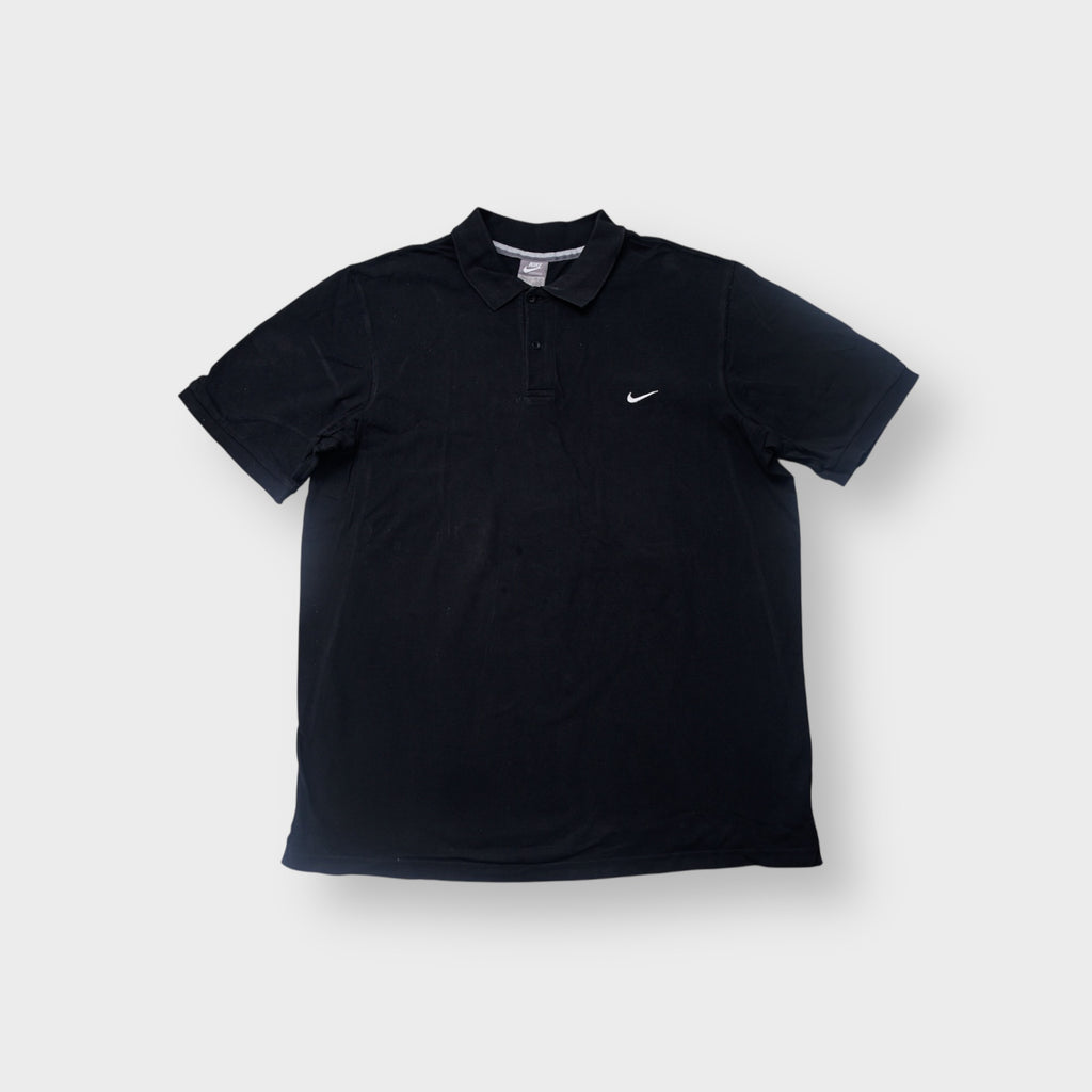 Nike polo shirt in black featuring a white swoosh logo embroidered on the chest