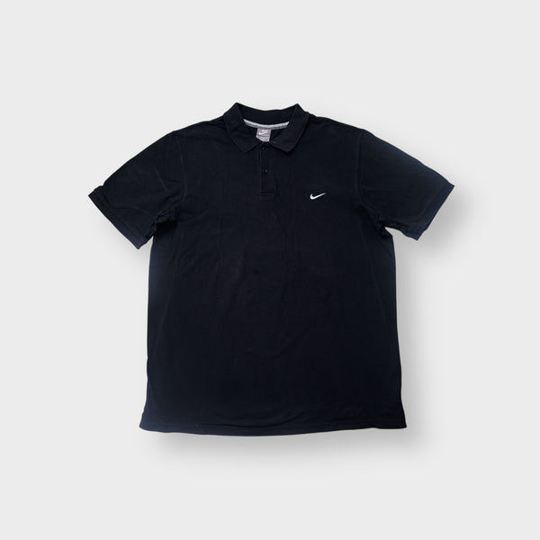 Nike polo shirt in black featuring a white swoosh logo embroidered on the chest