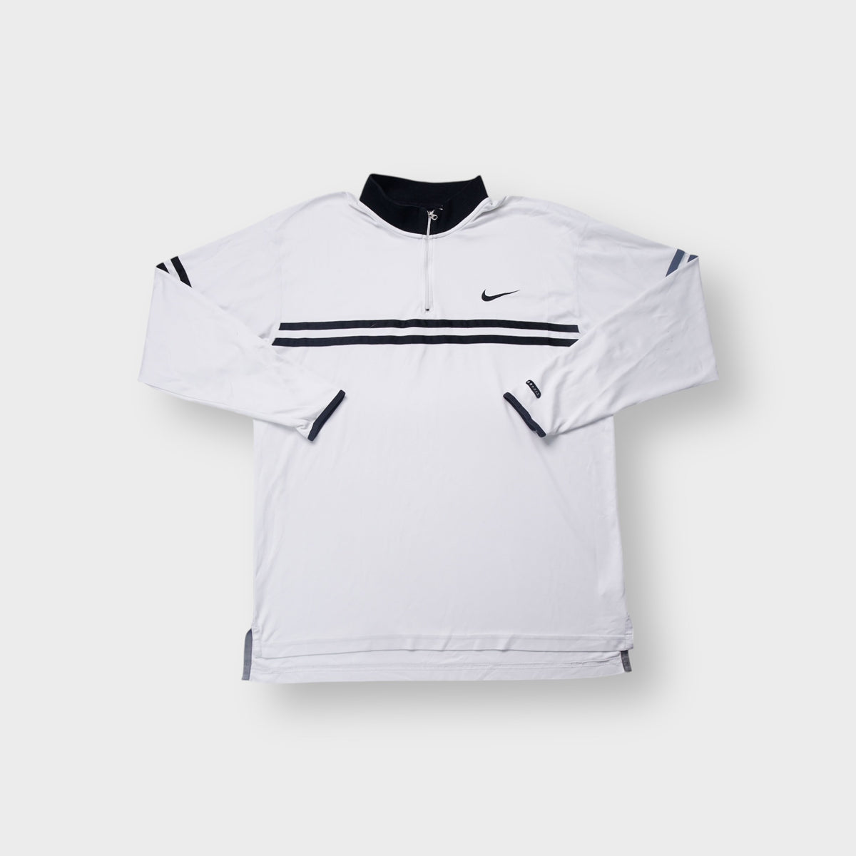 Nike polo shirt in white with navy chest stripes, half-zip neck, and embroidered swoosh