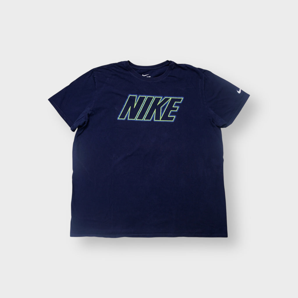 Nike T-Shirt in navy blue with a green outline logo graphic on the chest