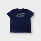 Nike T-Shirt in navy blue with a green outline logo graphic on the chest