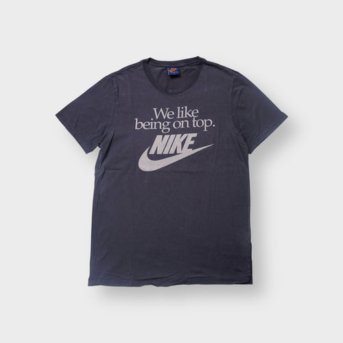 Nike T-Shirt in navy featuring a white printed slogan and Swoosh logo on the front