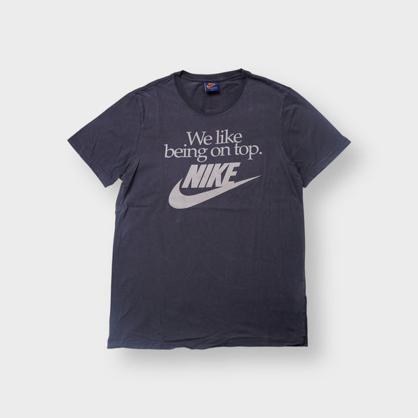 Nike T-Shirt in navy featuring a white printed slogan and Swoosh logo on the front
