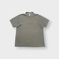 Nike polo shirt in olive green with a small white embroidered Swoosh on the chest