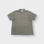 Nike polo shirt in olive green with a small white embroidered Swoosh on the chest