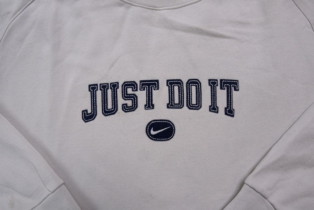 Nike sweater in grey featuring navy Just Do It embroidery and Swoosh patch, detail