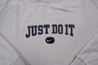 Nike sweater in grey featuring navy Just Do It embroidery and Swoosh patch, detail