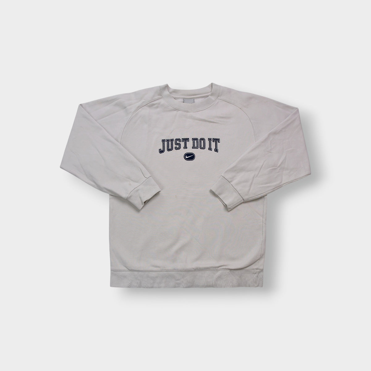Nike sweater in grey featuring navy Just Do It embroidery and Swoosh patch